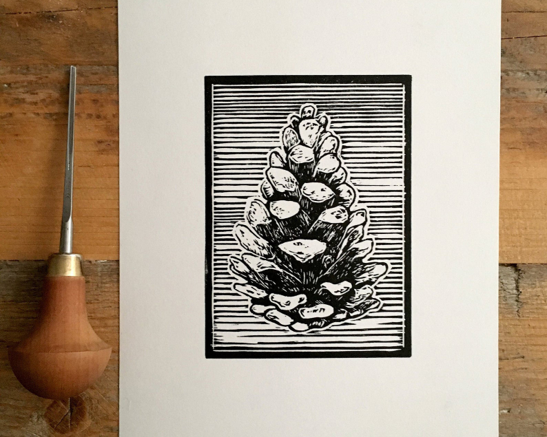 Pine cone linocut with carving tool